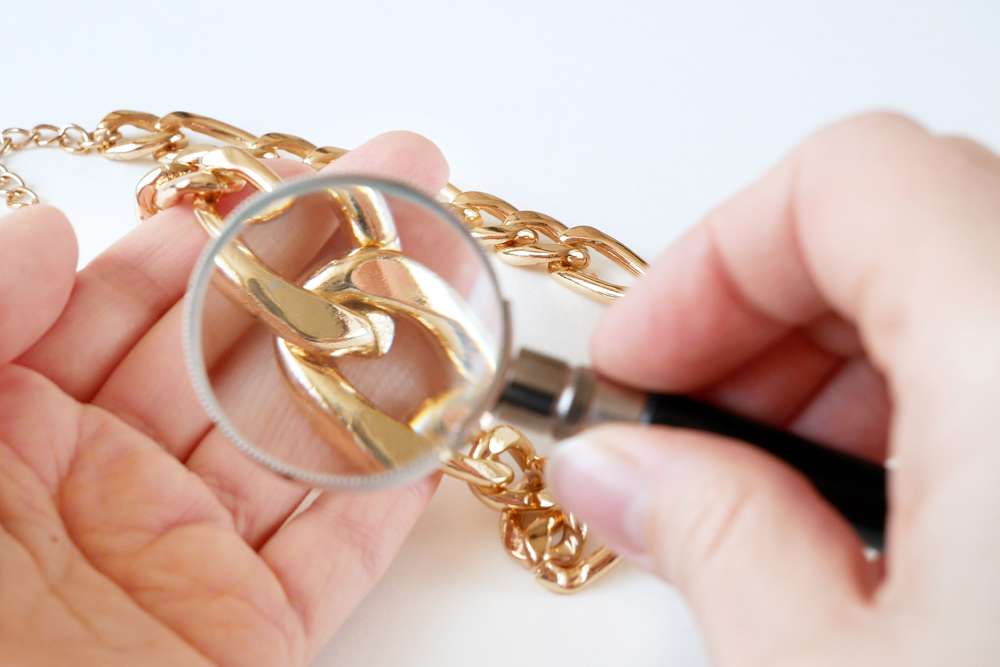 Looking at a gold chain through a magnifying glass