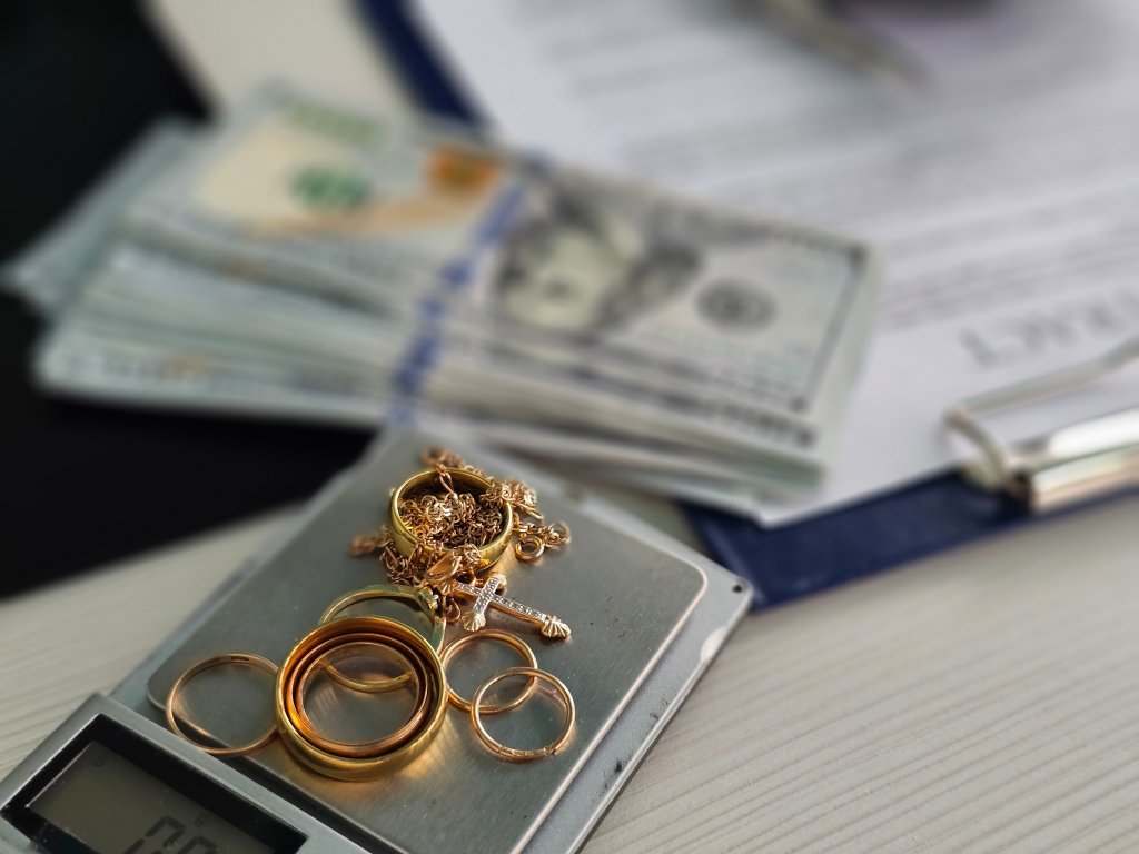 Gold jewelry being weighed on a scale at a pawn shop